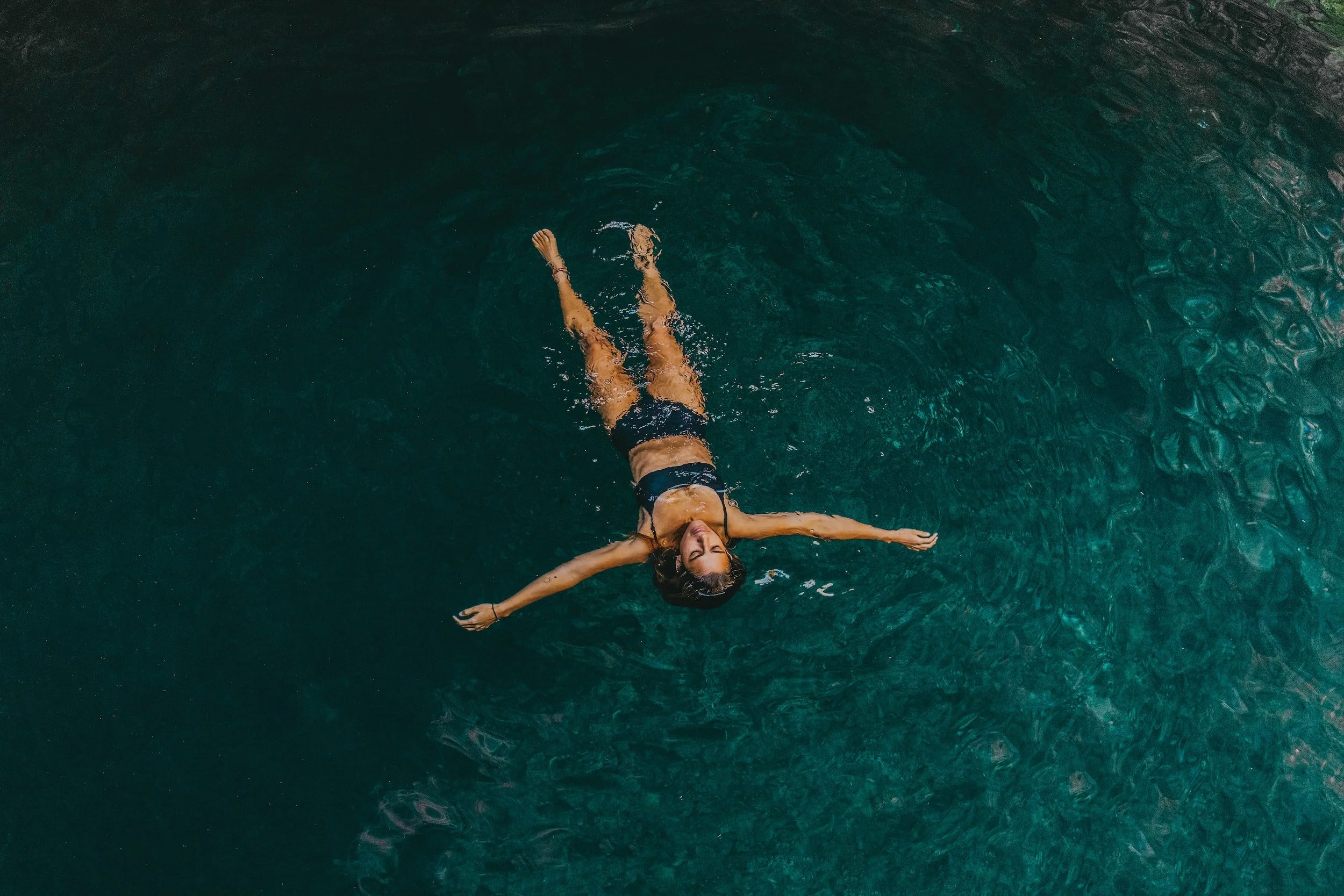 A girl is swimming in the pool of the Amansala all inclusive resort. 
