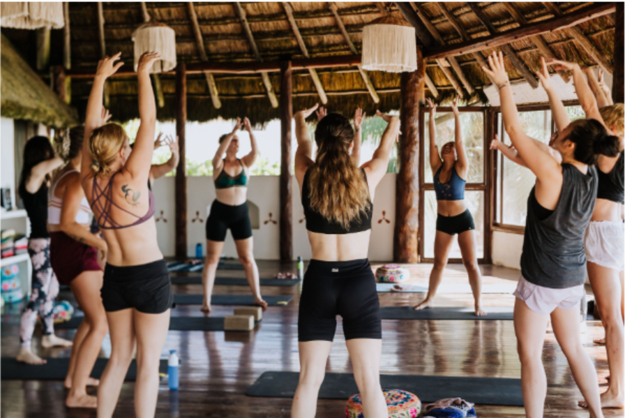 girls and boys are doing yoga in circle